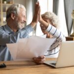 Happy elderly couple celebrate good news in letter