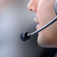 Close-up portrait of an Indian Customer Service Rep in office wearing a headset symbolizing support services